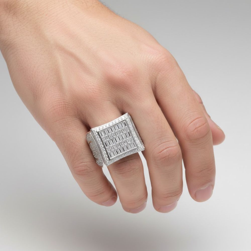 A hand showcases the 2.14ct Baguette Moissanite Square Head Fashion Ring, crafted in sterling silver with multiple rows of sparkling stones, set against a plain light gray background.