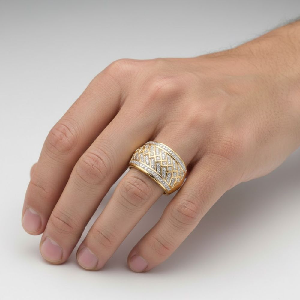 A close-up of a hand wearing the 10k Yellow Gold Diamond Band Ring 1/3 Cttw, featuring intricate diamond-studded patterns on the ring finger against a plain, light background.