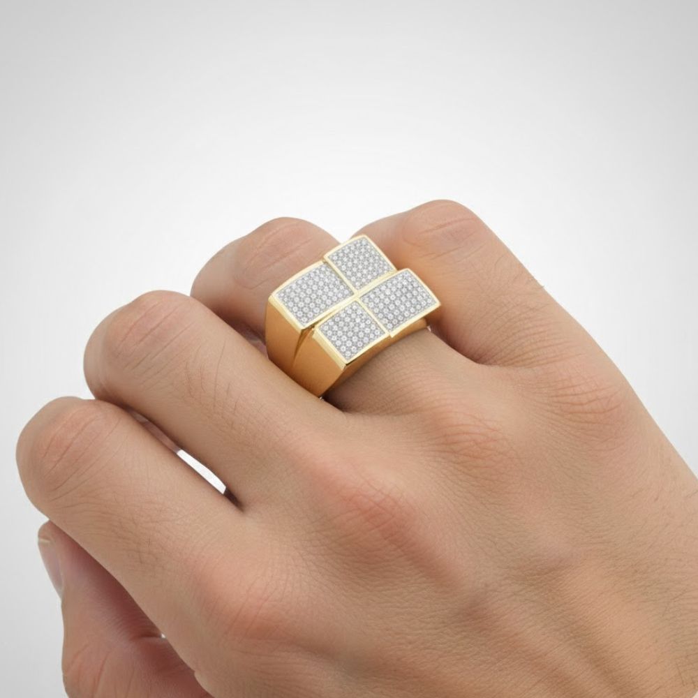 A hand wears a bold men's 10k yellow gold diamond square ring (1/2 Cttw), featuring four rectangular sections set with sparkling white stones.