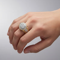 A hand showcases the 10K Yellow Gold Men’s Diamond Ring 7/8 CTW, featuring multiple channel-set natural diamonds, against a plain light gray background.