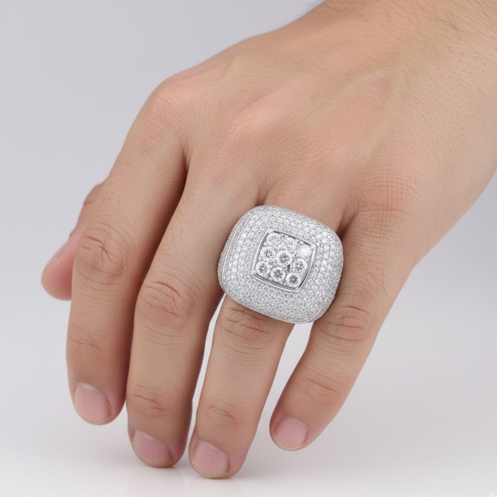 A hand wears the Silver Moissanite Square Head Ring, crafted from sterling silver and accented with sparkling moissanite stones and a central cluster of larger diamonds.