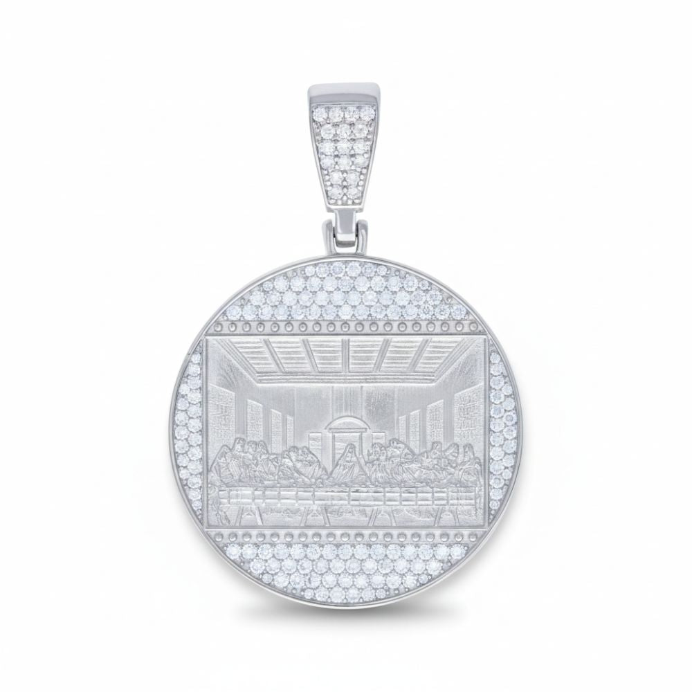 The Moissanite Last Supper Religious Charm Pendant features a round sterling silver design with an engraved depiction of the scene, surrounded by sparkling moissanite gemstones along the border and bail.