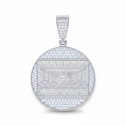 The Moissanite Last Supper Religious Charm Pendant features a round sterling silver design with an engraved depiction of the scene, surrounded by sparkling moissanite gemstones along the border and bail.