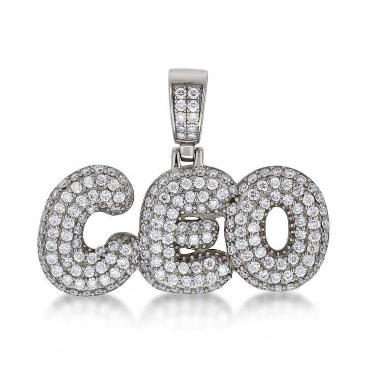 The Moissanite CEO Fashion Charm Pendant showcases the word "CEO" adorned with sparkling stones and a diamond-studded bail, creating an eye-catching sterling silver jewelry piece.