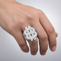 A hand displays the Silver Moissanite Dollar Sign Ring, made from 925 Sterling Silver with sparkling stones, worn on the middle finger against a simple light background.