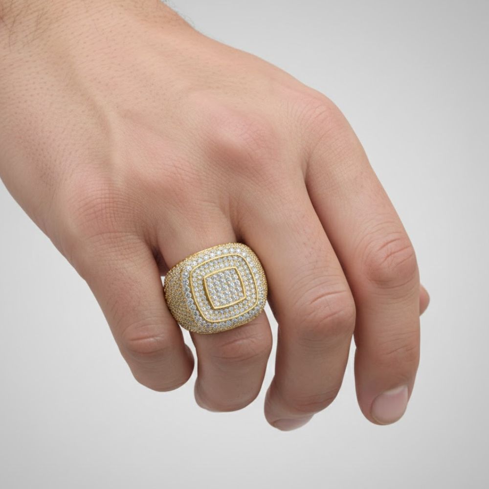 A hand displays the Layered Square Diamond Ring – 6.23 CT Gold Design, a large men's ring featuring multiple rows of small diamonds on a square gold band, worn on the ring finger against a plain light background.