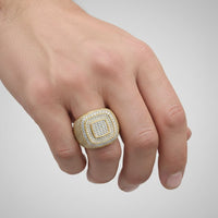 A hand displays the Layered Square Diamond Ring – 6.23 CT Gold Design, a large men's ring featuring multiple rows of small diamonds on a square gold band, worn on the ring finger against a plain light background.