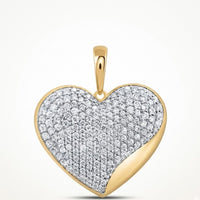 The 10K Yellow Gold 1 CTW Natural Diamond Heart Pendant features a heart-shaped design with sparkling diamonds on the front, a smooth gold accent on one edge, and a gold bail for attaching to your favorite chain.