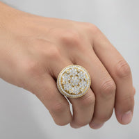 A hand showcasing the Round Cluster Diamond Ring – 4.65 CT Gold Design: a large, circular men's gold ring adorned with numerous sparkling diamonds in a cluster pattern against a plain, light background.