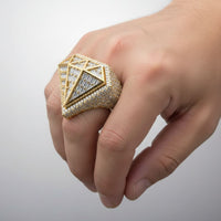 A hand displays the Radiant Diamond Shaped Ring – 6.65 CT Baguette Elegance, featuring geometric patterns and sparkling baguette stones, against a plain light background.