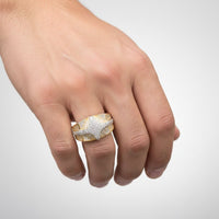 A close-up of a hand wearing the 1.57 CTW Natural Diamond Cluster Ring, crafted in 14k yellow gold with a star design, is shown against a plain light background.