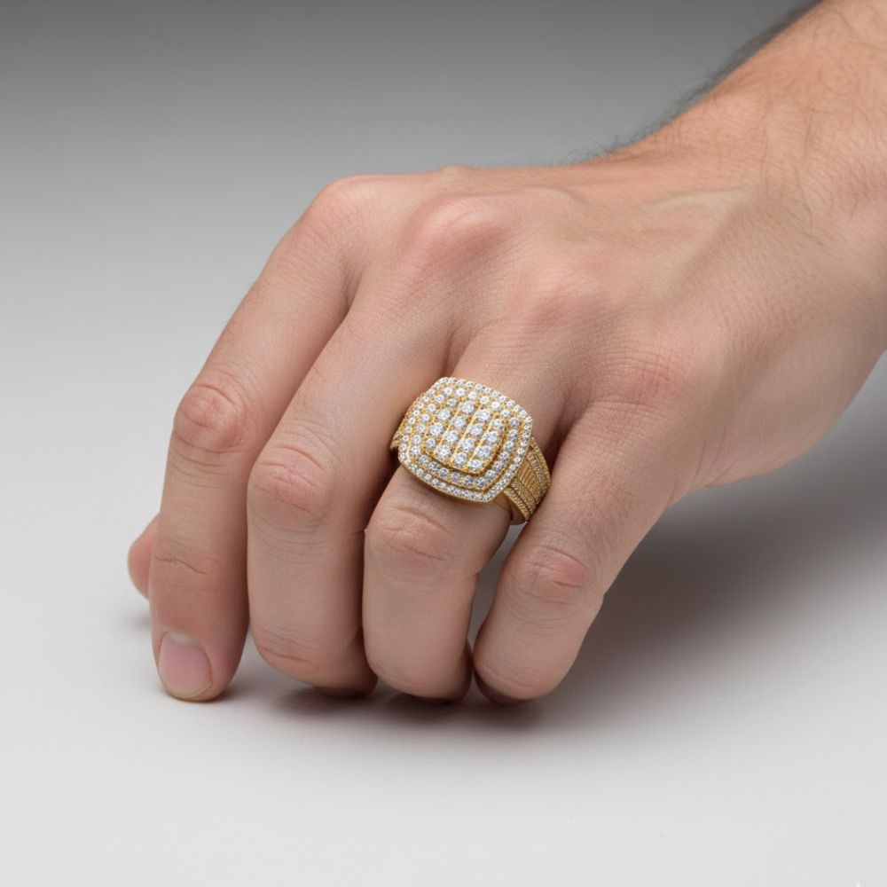 A close-up of a hand wearing the Square Diamond Pavé Ring – 2.19 CT Gold Design, featuring multiple rows of diamonds, set against a plain, light gray background.