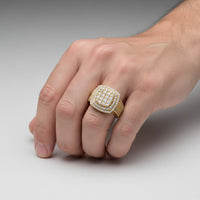 A close-up of a hand wearing the Square Diamond Pavé Ring – 2.19 CT Gold Design, featuring multiple rows of diamonds, set against a plain, light gray background.