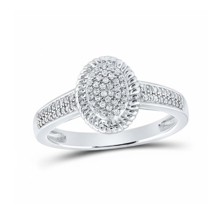 The 10k White Gold Diamond Oval Ring 1/5 Cttw features a central oval diamond cluster, a textured border, and extra diamonds on the upper band—making it an elegant anniversary gift.