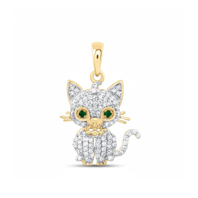 The 1/6CTW Diamond Cat Pendant in 10k Yellow Gold features diamond accents, green gemstone eyes, gold whiskers, and a gold flower on its chest, with a gold loop for attaching to your favorite chain.