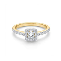 The 10k Gold Princess Diamond Halo Engagement Ring features a square-cut center diamond, a halo of 1/3 Cttw diamonds, and additional diamonds set along the upper half of the band.