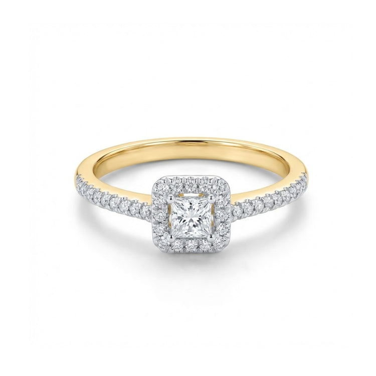The 10k Gold Princess Diamond Halo Engagement Ring features a square-cut center diamond, a halo of 1/3 Cttw diamonds, and additional diamonds set along the upper half of the band.