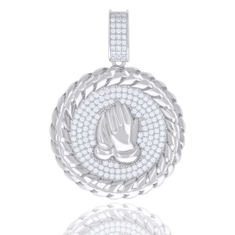 The 925 Silver Moissanite Praying Hands Symbol Charm features a round sterling silver pendant with sparkling moissanite stones and raised praying hands at the center, framed by a twisted rope border—an elegant piece of spiritual jewelry.