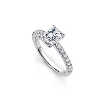 The Radiant-Cut Lab Grown Pavé Engagement Ring showcases a radiant-cut lab-grown diamond at the center with pavé-set round diamonds along the white gold band for a refined, elegant look.