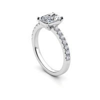 The Radiant-Cut Lab Grown Pavé Engagement Ring features a silver band with sparkling pavé-set diamonds and a striking radiant-cut center stone, offering timeless elegance.