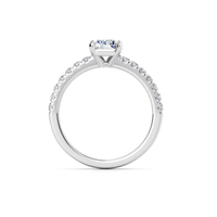 A radiant-cut lab grown pavé engagement ring with a prong-set solitaire diamond and pavé-set stones along the band, displayed against a white background.