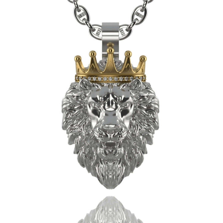 The Regal Lion Pendant with Crown - 14k Gold features a striking silver lion with a detailed mane and a gold crown adorned with gemstones, hanging from a silver chain and casting a shimmering reflection below.
