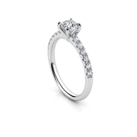 The Round-Cut Solitaire Lab Diamond Engagement Ring in white gold features a prong-set round lab diamond and small accent diamonds along the band, shown on a white background.