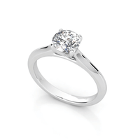 The Classic Round Solitaire Lab Grown Diamond Engagement Ring features a single round-cut lab diamond in a timeless four-prong setting, elegantly displayed on a white background.