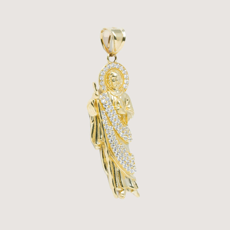 The Saint Jude Pendant in 14K yellow gold features a robed figure with white CZ sparkle, a halo, and chain loop—an elegant men's religious jewelry piece highlighted against a simple background.