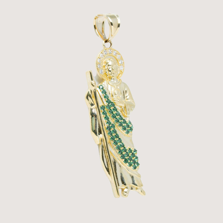 The Saint Jude Pendant in 14K Yellow Gold – Green CZ Brilliance for Men features a saint holding a staff, accented with green and white gemstones on the robe and halo, set against a plain light background.