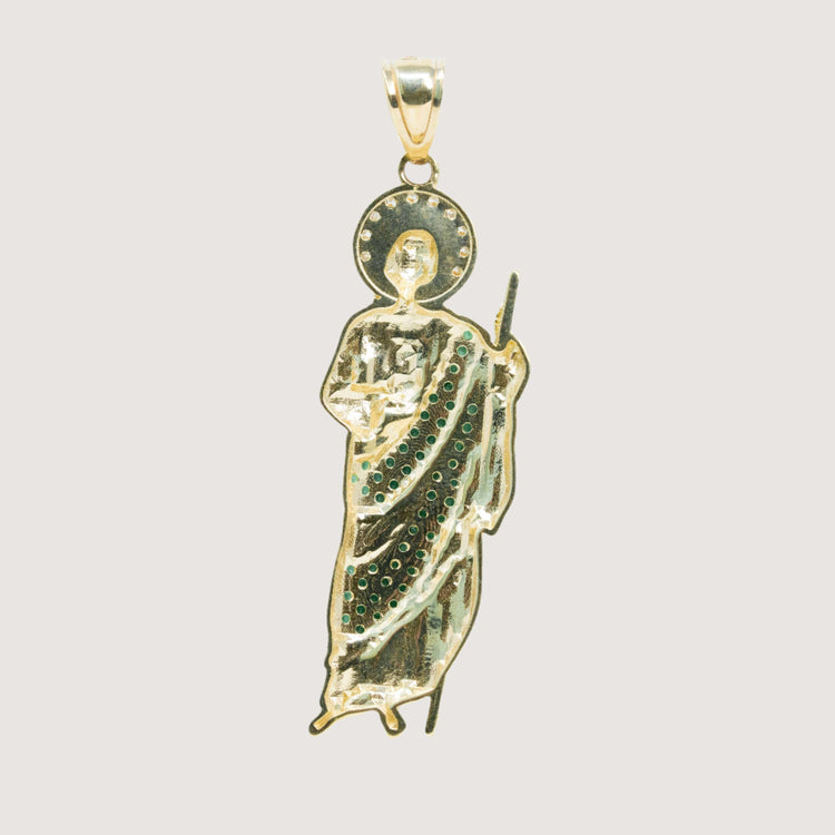 The Saint Jude Pendant in 14K Yellow Gold features a saintly figure with a halo, staff, and robe embellished with green CZ stones—an elegant men's accessory set against a plain light background.