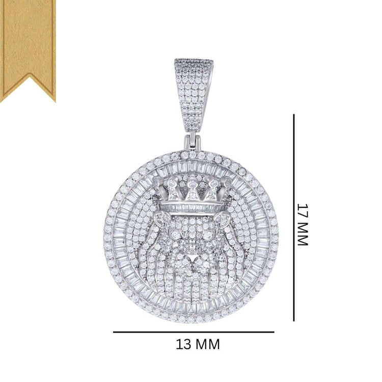 The Silver Round Baguette Moissanite Lion Charm Pendant by GOLDZENN features a diamond-encrusted crowned lion face design, measuring 37 mm high by 13 mm wide, with a gold ribbon visible in the image’s upper left corner.