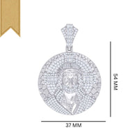 The Silver Round Baguette Moissanite Jesus Charm Pendant is crafted in 925 sterling silver, featuring a detailed face, intricate patterns, and a gold ribbon accent on the upper left corner. It measures 54 mm by 37 mm.