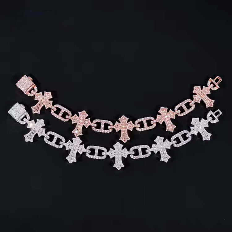 Two chain bracelets with cross-shaped links rest on black, featuring the Silver Cross Infinity Moissanite Men Bracelet sparkling next to a rose gold piece, both accented with stones for a bold touch to any men’s jewelry collection.