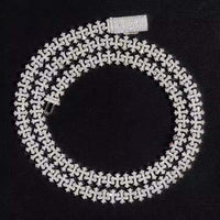 The Silver Cross Moissanite Necklace, featuring sparkling moissanite stones in an elegant design, is displayed in a spiral shape on a black background.