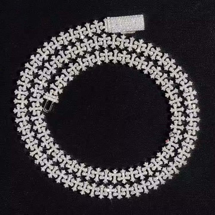 The Silver Cross Moissanite Necklace, featuring sparkling moissanite stones in an elegant design, is displayed in a spiral shape on a black background.