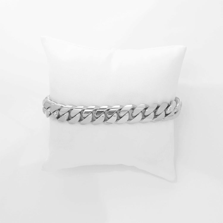 The 12mm Handmade Miami Cuban Link Bracelet, crafted from 950 silver, is showcased elegantly on a white cushion set against a plain white background.