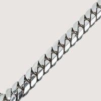 A close-up of the Silver Cuban Link Bracelet - Ready to Ship, featuring interlocking polished links on a plain light background. The perfect accessory to add timeless style to any look.
