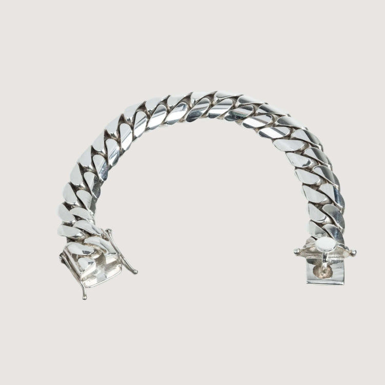 The Handmade Miami Cuban Link Bracelet in 950 Silver features a box clasp and an elegant, thick silver chain. Displayed unfastened on a light neutral background, it’s handcrafted and ready to ship.