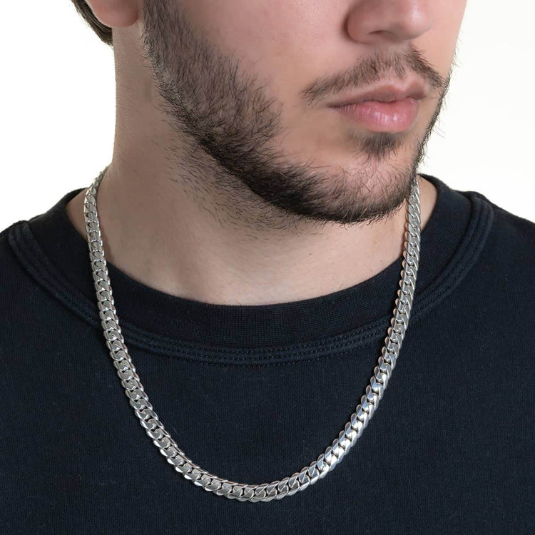 Close-up of a man wearing a black crewneck and the 8mm Handmade Miami Cuban Link Chain - 950 Silver. Only the lower half of his face with trimmed facial hair is visible.