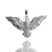 The Silver Eagle Pendant features outstretched wings, detailed feathers, and a chain loop. Displayed on a white background with its reflection, this striking piece is crafted as a solid silver pendant.