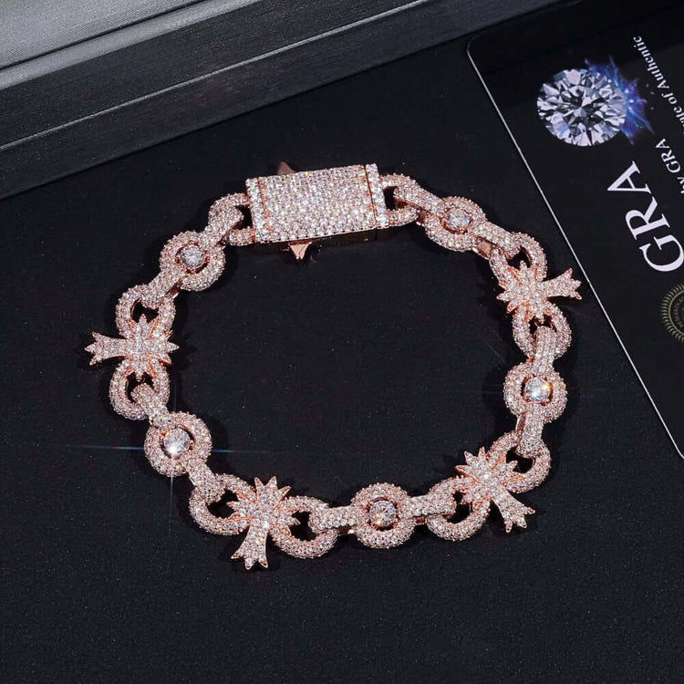 The Silver Moissanite Cross Infinity Bracelet pairs beautifully with a gold chain bracelet encrusted with small diamonds, featuring a rectangular clasp and star-shaped accents, displayed on a dark surface next to its certification card.