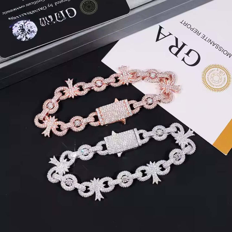 A Silver Moissanite Cross Infinity Bracelet with sparkling, diamond-like stones and unique links is displayed on a black surface beside a certificate and jewelry box.