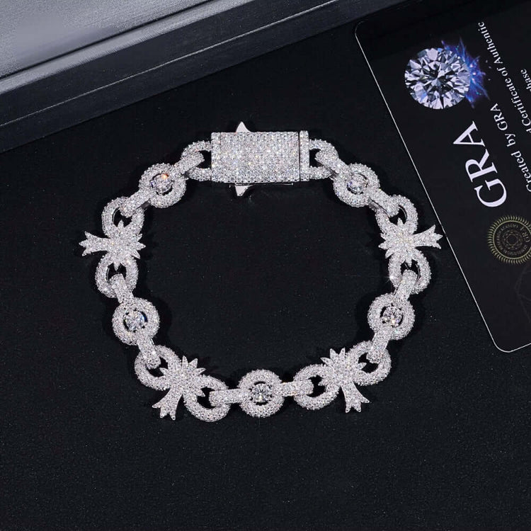 The Silver Moissanite Cross Infinity Bracelet, featuring a decorative pattern and rectangular clasp, is shown on a black surface beside a GRA certificate card.