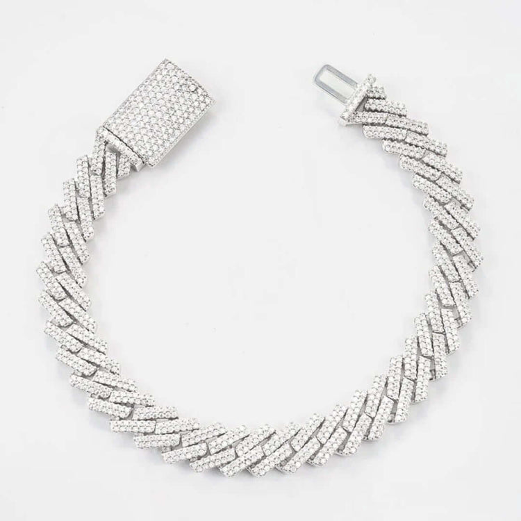 The Silver Moissanite Cuban Link Bracelet – 10mm features a 925 silver Cuban link design with a zigzag pattern, sparkling white stones, and a large rectangular clasp. Shown on a white background.