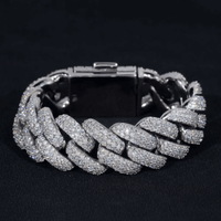 The Silver Moissanite Cuban Link Bracelet – 20mm features a chunky design with shimmering stones set in polished 925 silver, shown against a black background.