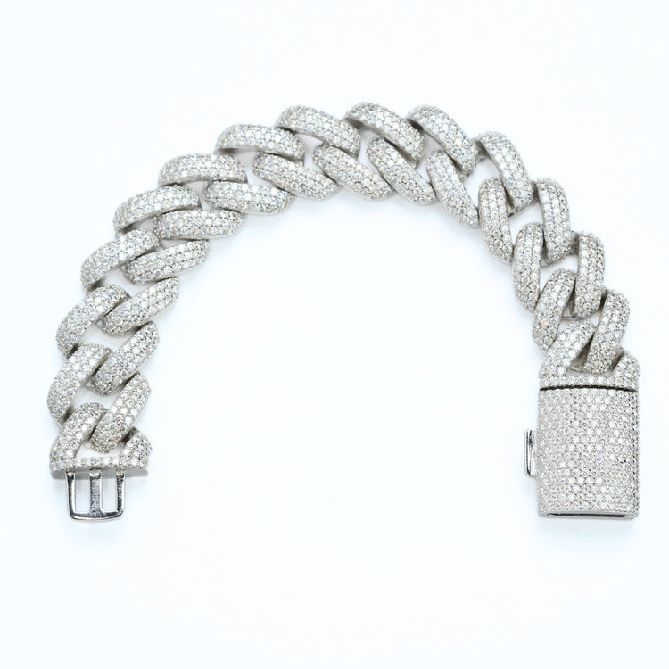 The Silver Moissanite Cuban Link Bracelet – 20mm features a thick, curved design set with small, sparkling moissanite stones, shown against a white background.