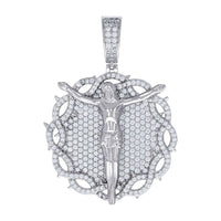 The Silver Round Moissanite Crucifix Charm Pendant showcases Jesus with outstretched arms on a round, VVS moissanite-studded backdrop framed by thorns. Its bail is also adorned with sparkling moissanite stones.