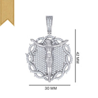 The Silver Round Moissanite Crucifix Charm Pendant is crafted in sterling silver with VVS moissanite, circular detailing, and a gold ribbon on the top left. It measures 42mm tall by 30mm wide.