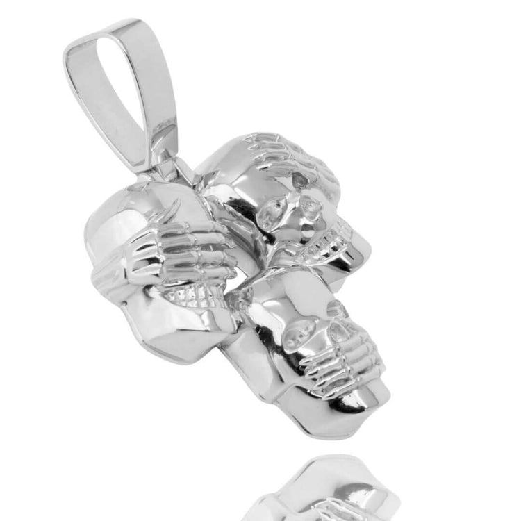 The Hear No Evil, See No Evil, Speak No Evil Silver Pendant features three silver skulls, each partially covered by skeletal hands in a polished cluster design—an edgy interpretation of mindful jewelry.